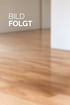 Platzhalter für ein Produktfoto mit dem Text "BILD FOLGT" vor einem unscharfen Hintergrund mit Parkettboden.