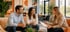 A couple smiles while listening to a financial advisor holding a clipboard.