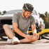 A cyclist holding his knee in pain from a sports injury.