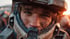 A young man with blue eyes and a dirty face looks forward, wearing a dirty, worn sci-fi helmet.
