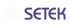 Logo mit weißer blumenähnlicher Form und violettem Text „SETEK“ auf grünem Hintergrund.