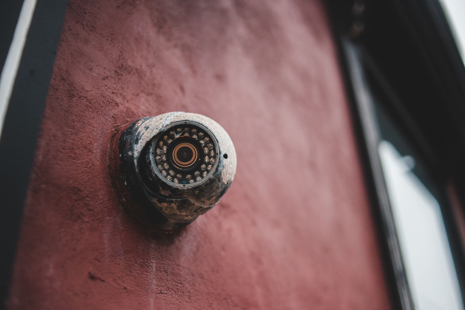 Older security equipment on a house wall awaiting service