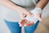 Person holds bandaged hand, highlighting chronic wound healing care.