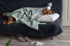 Woman resting under blanket with fatigue, possible fibromyalgia symptoms