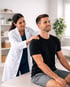 Chiropractor performs shoulder treatment on male patient in clinic