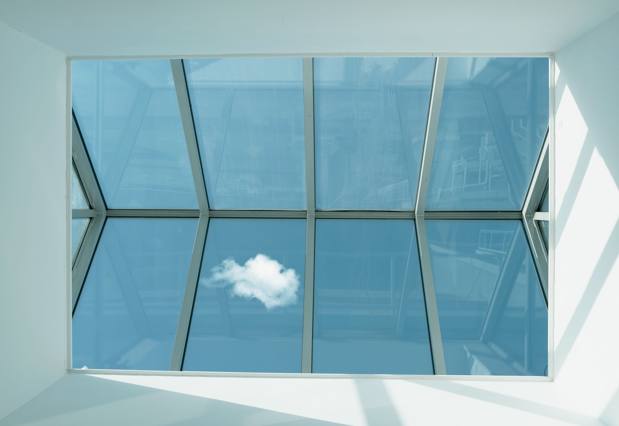Glass skylight seen from below against a blue sky, the kind of unit to check first when a skylight is leaking in a Plano home