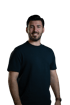 Ein lächelnder Mann mit dunklem Haar und Bart trägt ein schwarzes T-Shirt vor grünem Hintergrund.
