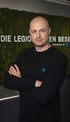 Patric Rempel vor dem Logo der Legionellenbeseitiger