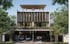 Modern 3-story duplex house with two garages, each holding two cars, surrounded by trees.