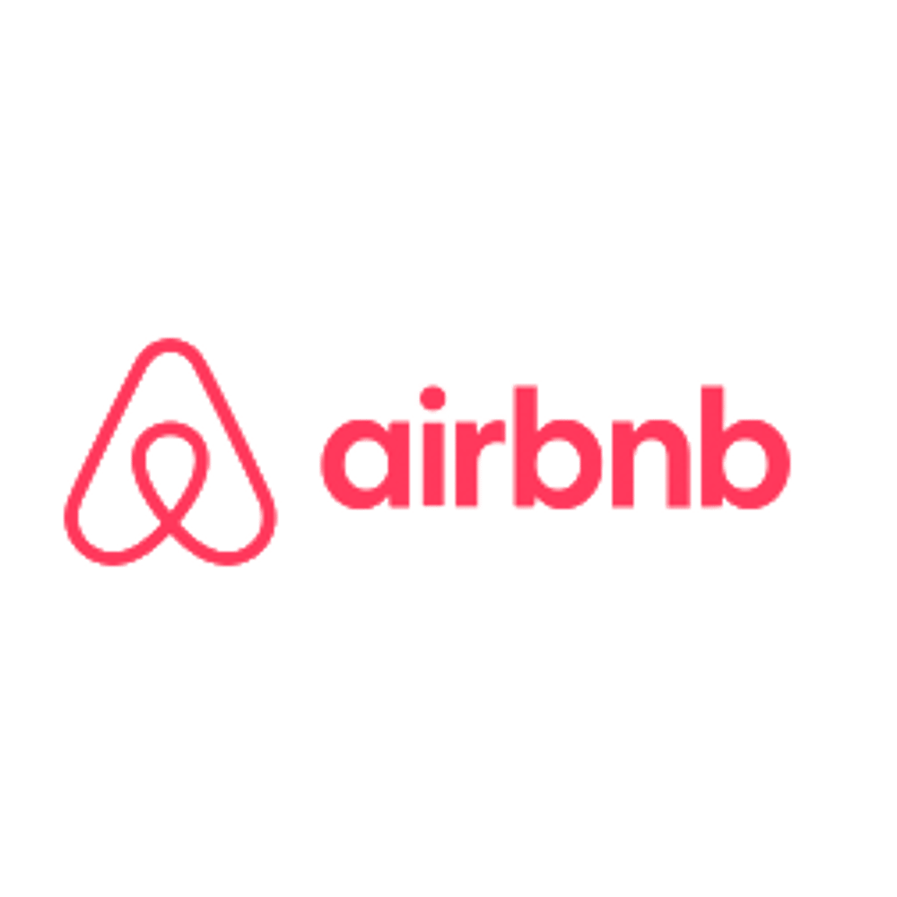 Das rosafarbene Airbnb-Logo mit dem Bélo-Symbol und dem Schriftzug auf schwarzem Hintergrund.