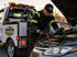 Towing Eastvale jump start service technician testing and boosting a dead car battery with professional roadside assistance equipment