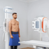 Male patient undergoing digital X-ray imaging
