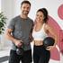 Happy duo with kettlebell and ball, ready for sports after pelvic therapy.