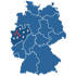 Karte Deutschlands mit roten und grauen Stecknadeln in Nordrhein-Westfalen.