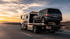 Towing Corona long-distance towing service transporting an SUV safely on a flatbed tow truck along the highway.
