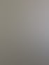 Strukturierte Wand mit unregelmäßigen grünen, braunen und grauen Flecken.