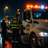 Eastvale 24/7 Towing Services flatbed tow truck assisting a stranded driver with vehicle recovery at night