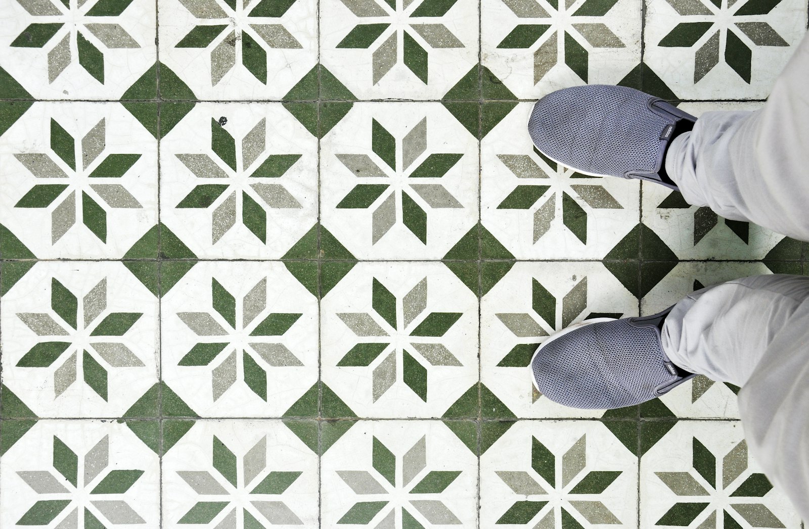 Large-format porcelain tile being set on a prepared floor