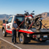 Towing Sandy motorcycle towing service securing a motorcycle on a flatbed tow truck for safe transport across Sandy, Utah.