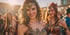 A smiling woman in a Wonder Woman costume and tiara, with another costumed woman behind her.