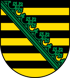 Wappen mit fünf gelben und fünf schwarzen Streifen, diagonal geteilt durch einen grünen Rautenkranz.