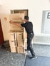 Umzugshelfer trägt Umzugskarton – günstiges Umzugsunternehmen Saarbrücken für Möbeltransport und Umzugsservice im Saarland