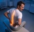 Man clutching lower back, indicating back pain.