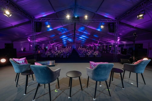 Eventzelt mit farbiger Ambientebeleuchtung und Loungemöbeln