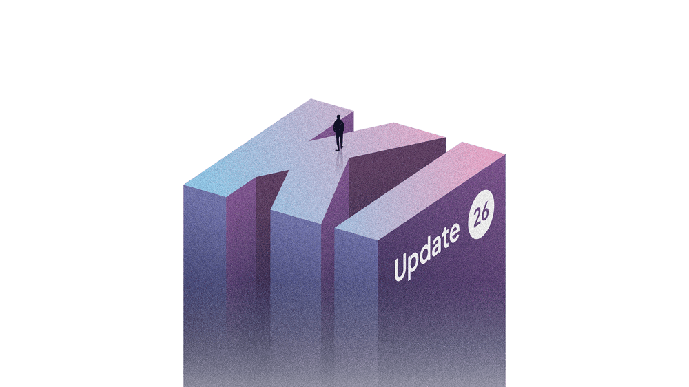 Eine Person steht auf einem großen 3D-Buchstaben „KI“ mit dem Text „Update 26“.