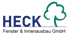 Logo der Firma Heck mit blauem Text "HECK" und einem grünen Baumumriss, darunter "Fenster & Innenausbau GmbH".