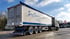 Weißer LKW mit Auflieger der Firma Eckert-Transporte parkt auf Asphalt bei sonnigem Wetter.
