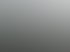 AERMEC Klimaanlage auf einem Flachdach mit Blitzableitern und Bäumen im Hintergrund.
