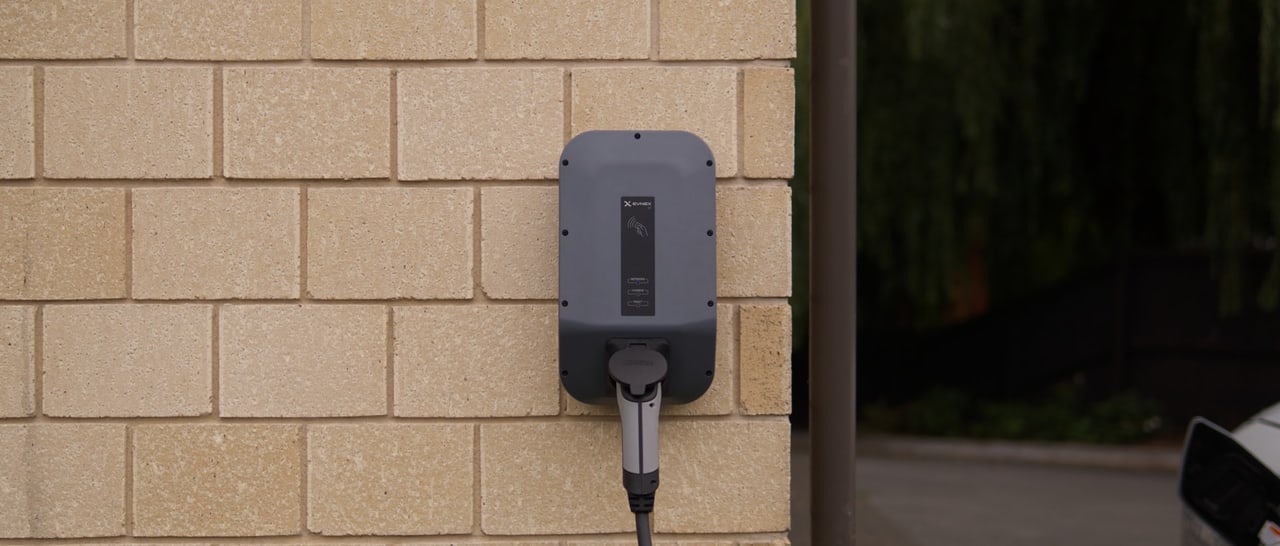 Wall-mounted EV charging equipment on a garage wall