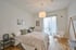 Schlafzimmer mit Parkett und Fenstertür