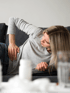 Woman on couch with lower back pain, pelvic floor health focus