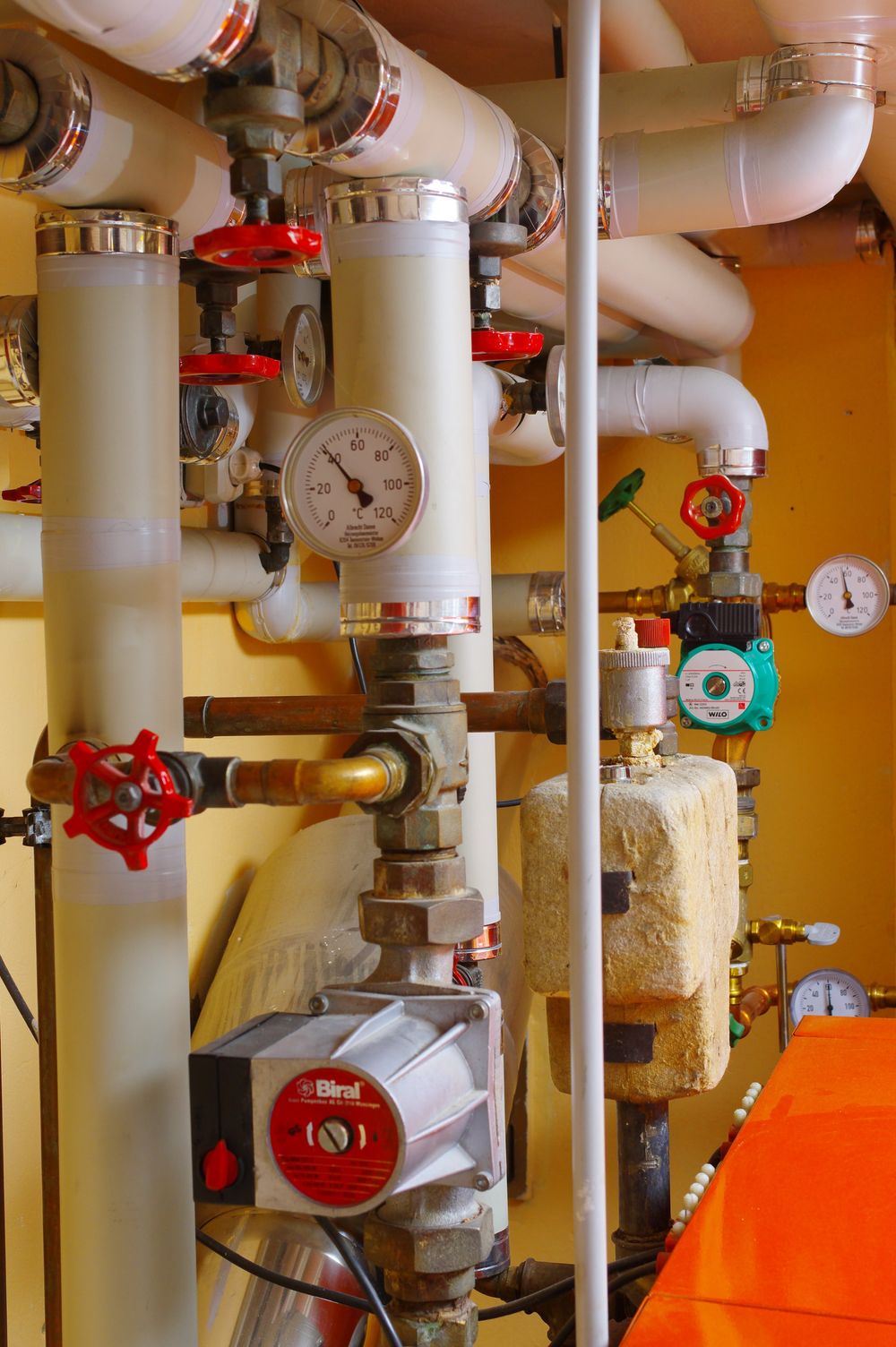 Heizungsverteilung mit Umwälzpumpen, Absperrventilen, Thermometern und gedämmten Rohrleitungen