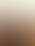 Zwei lachende Frauen stehen bei Sonnenuntergang in einem Feld und schauen einander an.