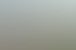 Mittelalterlicher Wachturm mit gewundener Laterne auf einer Burgmauer, dahinter bewaldete Hügel unter bewölktem Himmel.