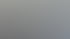 Ein Mann mit Brille und blauem Hemd sitzt in einem Büro und spricht.